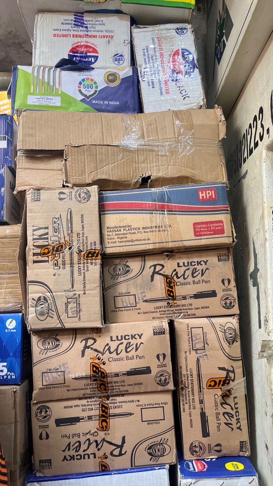 Cartons of ball pens stacked in the shop